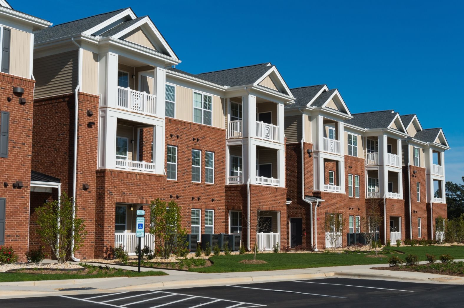 Outside view of a suburban apartment building on a sunny day.